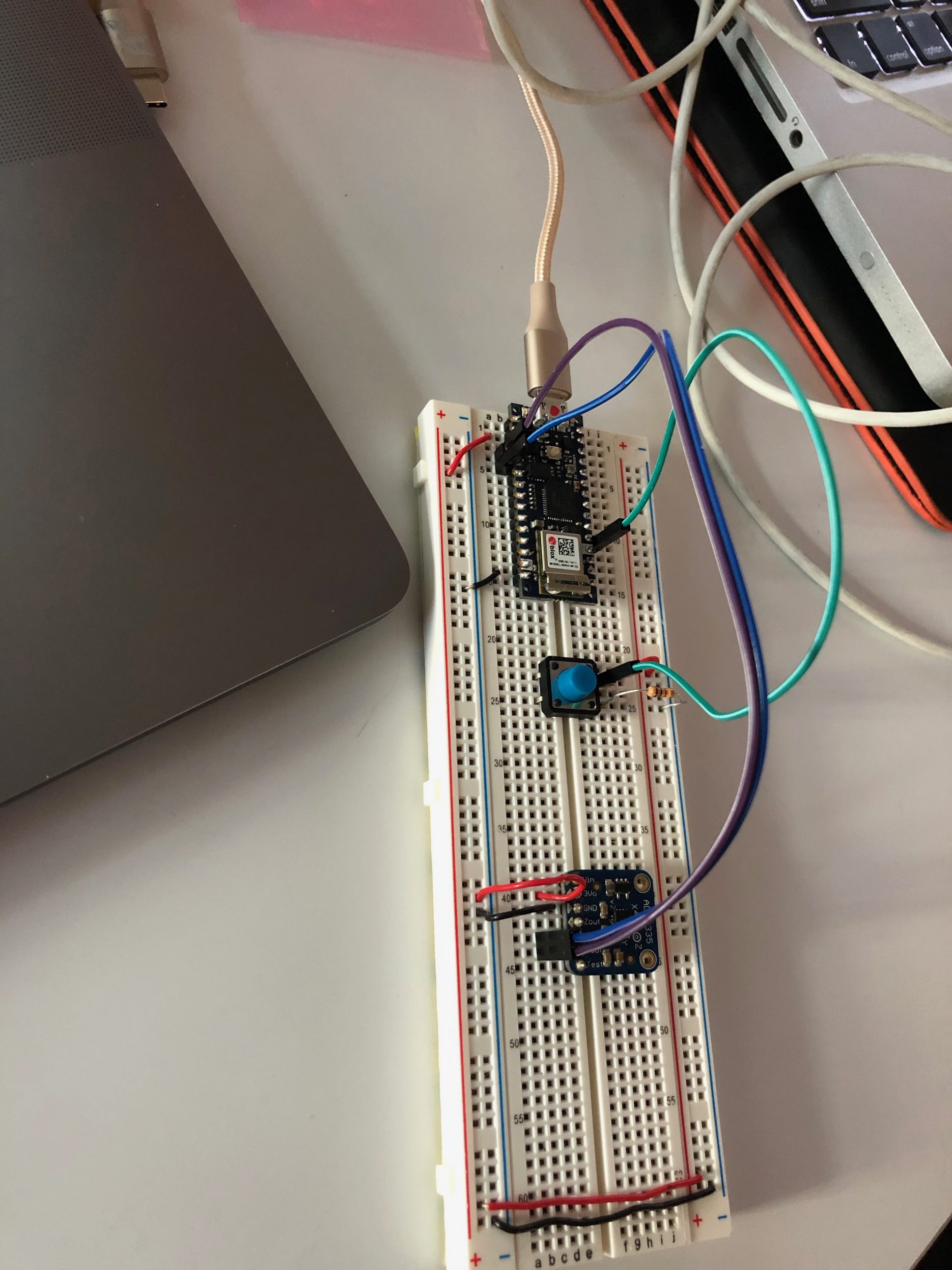 Breadboard setup with accelerometer and button.