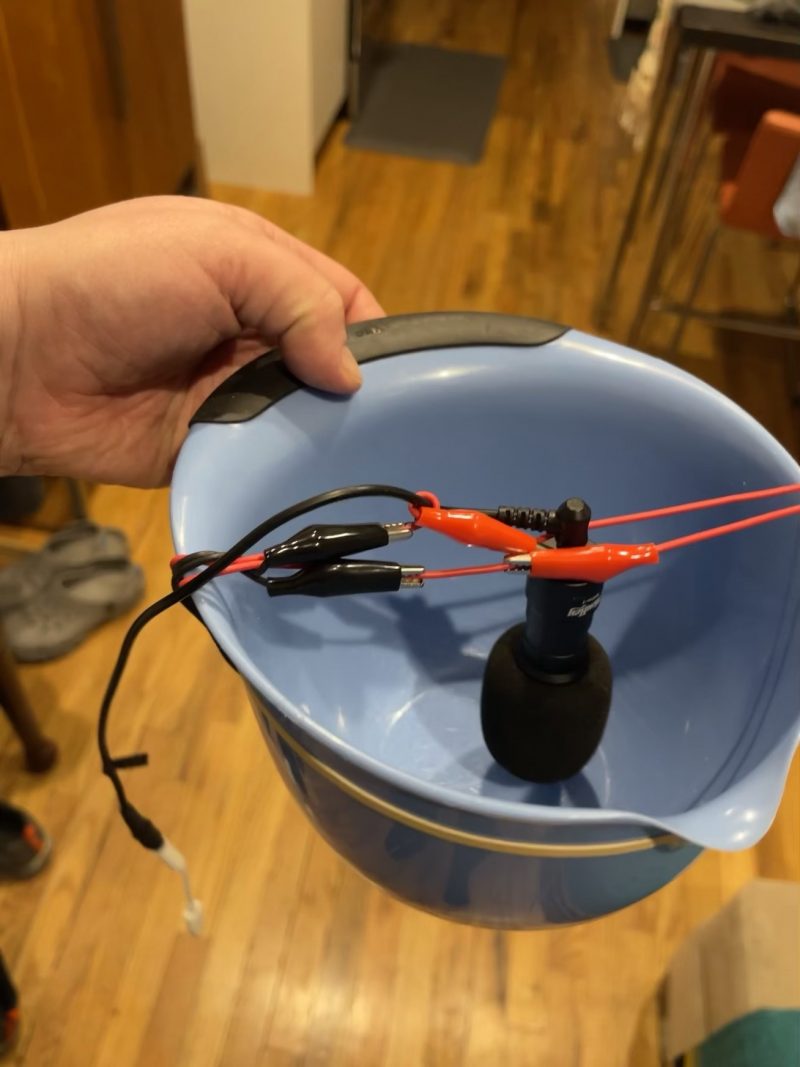 Another view of my nocmig mic set up. A mini shotgun mic suspended over a bowl from a couple of connected wires with alligator clips.